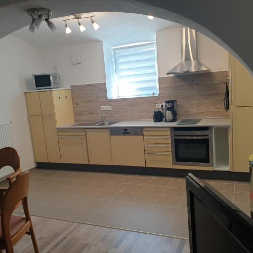 a kitchen with a sink and a stove top oven at FeWo PAN in Pfarrkirchen