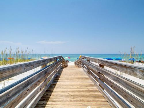 a wooden boardwalk leading to the beach at Emerald Isle #401 in Pensacola Beach