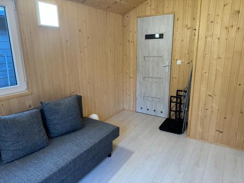 a living room with a couch and a door at U Joanny in Kopań