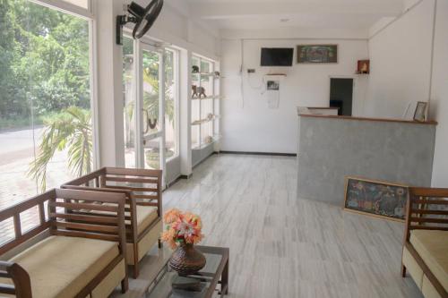 a living room with two chairs and a table at Royal Inside Hotel in Udawalawe