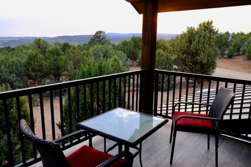 a porch with a table and chairs on a balcony at Juniper Ridge Luxury Two-bedroom Casita Zion E in Orderville