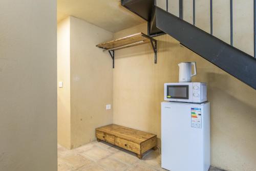 a microwave on top of a refrigerator in a room at Casa Batroun Lofts in Batroûn