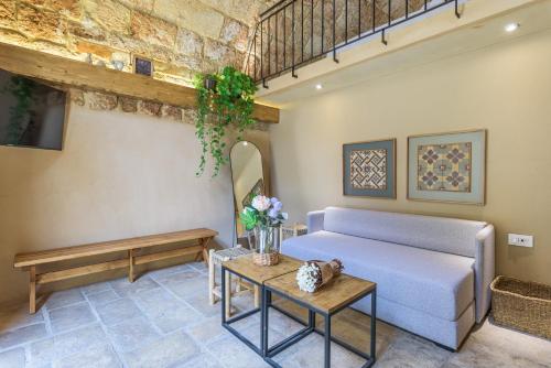 a living room with a couch and a table at Casa Batroun Lofts in Batroûn