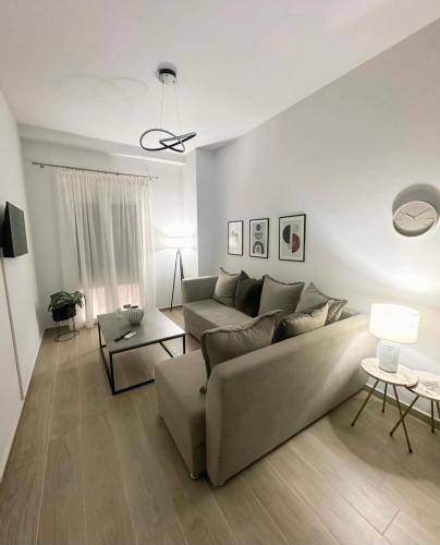 a living room with a couch and a table at Iliana's apartment 2 in Kardítsa