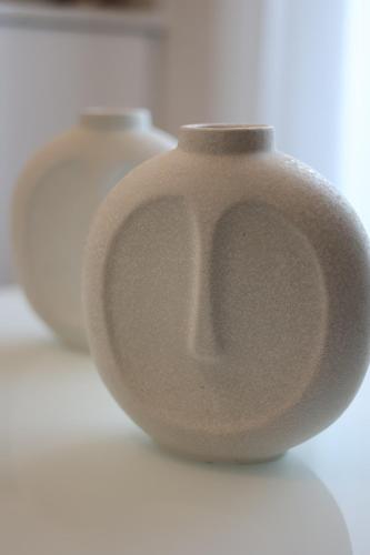 a gray vase sitting on a white surface at Iliana's apartment in Kardítsa