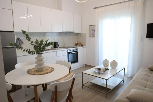 a kitchen and living room with a table and a couch at Iliana's apartment in Kardítsa