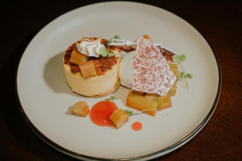 a white plate with a dessert on a table at Redesdale Arms Hotel in Moreton in Marsh