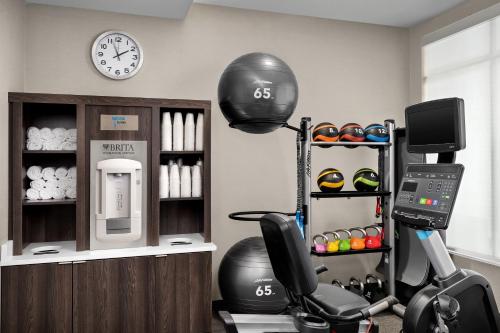 a room with a gym with a treadmill and a clock at Residence Inn by Marriott Indianapolis Plainfield in Plainfield