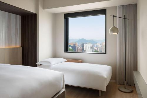 Ein Bett oder Betten in einem Zimmer der Unterkunft Courtyard by Marriott Sapporo