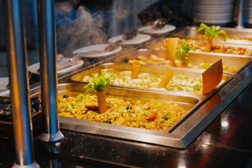 a buffet with many different types of food in trays at Nahrawess Resort & Thalasso in Hammamet