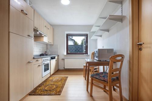 a kitchen with a table and a dining room at Gemütliche Wohnung Buchholz i d N in Buchholz in der Nordheide