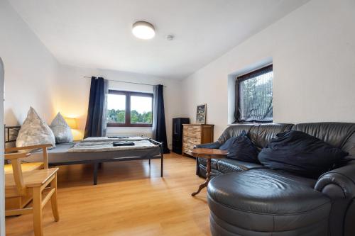 a living room with a couch and a table at Gemütliche Wohnung Buchholz i d N in Buchholz in der Nordheide