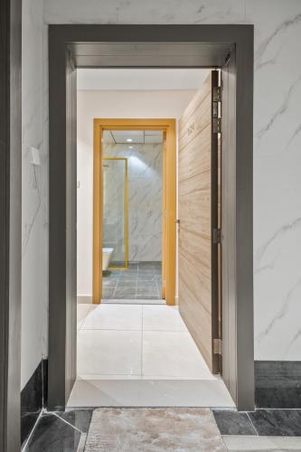 an open door to a hallway with a bathroom at Bright Studio In Vibrant Dubailand District in Dubai