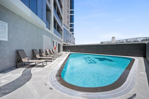 a swimming pool on the side of a building at Bright Studio In Vibrant Dubailand District in Dubai