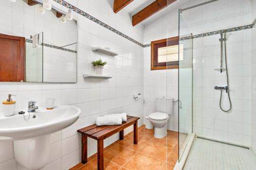 a bathroom with a sink and a toilet and a shower at Villa Proa by Villa Plus in Alaior