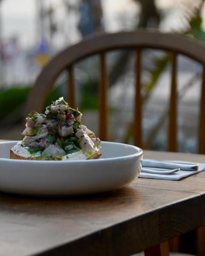 a white plate of food on a table at Dream Beach 98 Hotel And Spa - Affordable Seaside Choice 2025 in Tel Aviv
