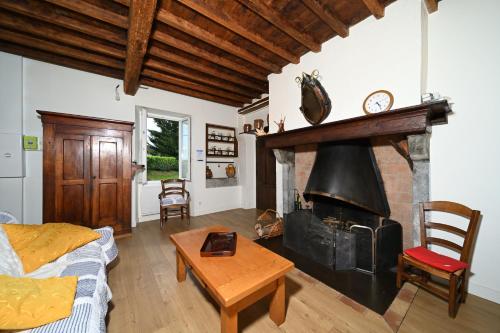 a living room with a fireplace and a couch at La maison Bayle in Mauvezin