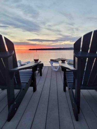 a group of chairs sitting on top of a dock at Georgian Legendary Tobermory Retreat With Hot Tub in Tobermory