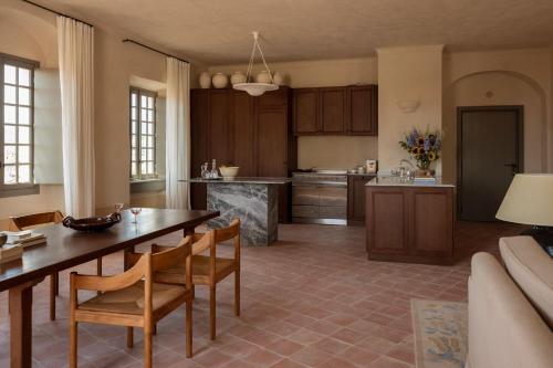 a kitchen and dining room with a table and chairs at Hôtel du Couvent, a Luxury Collection Hotel, Nice in Nice