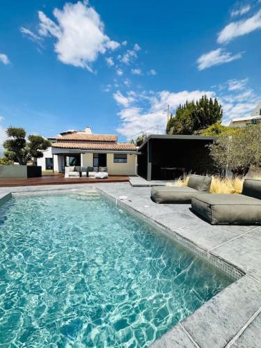 une piscine devant une maison dans l'établissement Magnifique villa de 220m2,piscine,vue mer, à Cagnes-sur-Mer