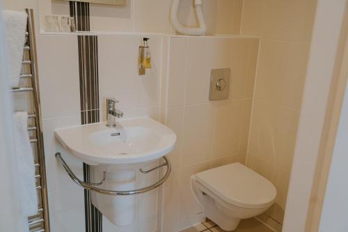 a bathroom with a sink and a toilet at Redesdale Arms Hotel in Moreton in Marsh