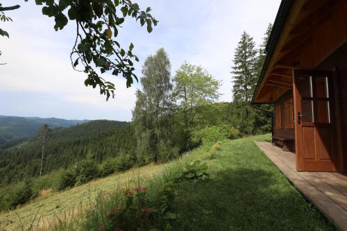 a house on a hill with a view of the mountains at Chalupa Štrčková - srdce Valašska in Vsetín