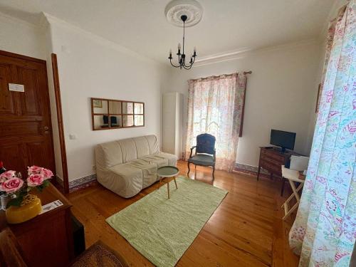 a living room with a couch and a chair at Casa da Villa 1B in Sintra
