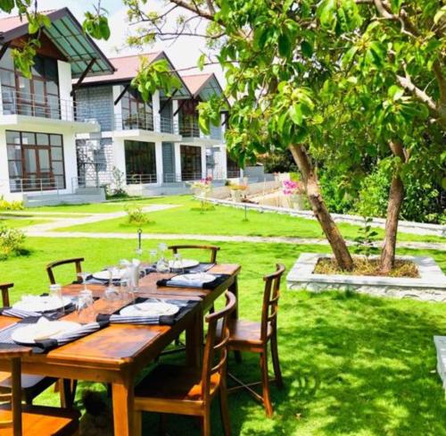 a wooden table in the yard of a house at Kalpitiya Chalets by Thilanka in Kalpitiya