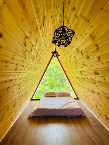 a bedroom in a tree house with a window at Demetra in Buknari