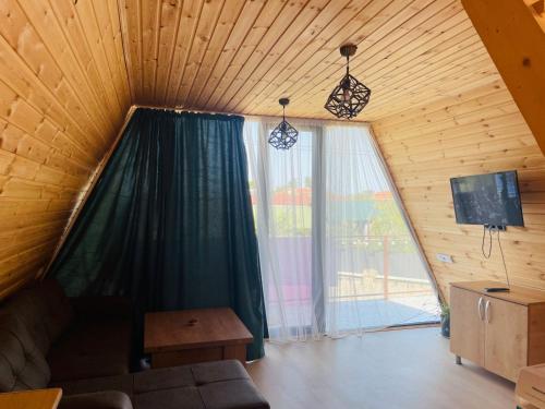 a living room with a large window and a couch at Demetra in Buknari