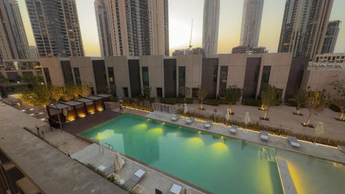 an overhead view of a swimming pool in a city at Luxury 2 Bedroom Poolside Haven in Dubai Creek Harbour in Dubai