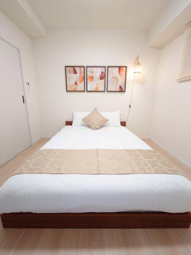 Postel nebo postele na pokoji v ubytování Neighbor's Hotel 十日市