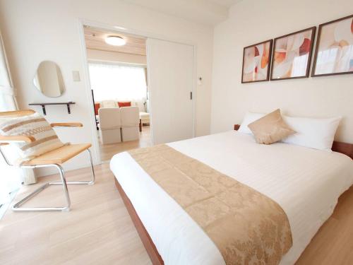 Postel nebo postele na pokoji v ubytování Neighbor's Hotel 十日市