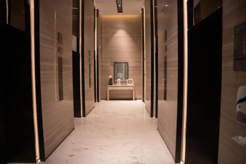 a hallway of a hotel with a mirror and a sink at Luxury 2 Bedroom Poolside Haven in Dubai Creek Harbour in Dubai