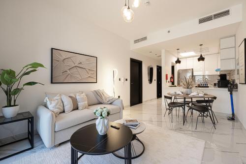 a living room with a couch and a table at Brand New 1BR with Pool, Sauna & Gym in Dubai