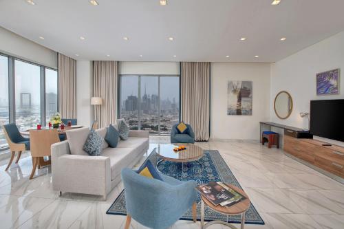 a living room with a couch and a table at SUHA Mina Rashid Hotel Apartments in Dubai