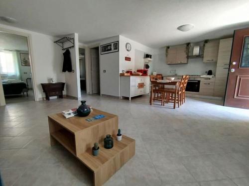 a living room with a table and a kitchen at Casa a 7 minuti da aeroporto FCO vicino fiera di Roma!! in Fiumicino