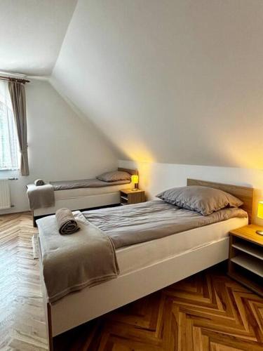 a bedroom with two beds in a room at Brigetio Kúria in Komárom