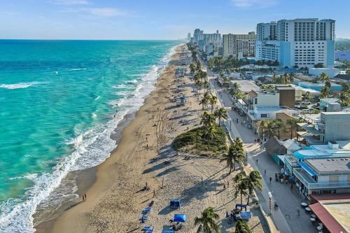 an aerial view of a beach with palm trees and the ocean at Two Bedroom Hollywood Beach Vacation Sc01 in Hollywood