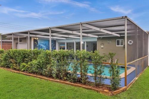 a house with a swimming pool in the yard at Vacation Villa W Heated Pool Beach & Casino in Hollywood