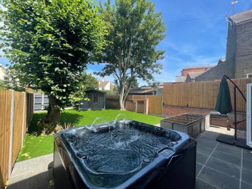 a hot tub in the backyard of a yard at Amber House in Gorleston-on-Sea