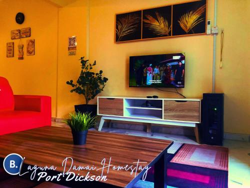 Una televisión o centro de entretenimiento en Laguna Damai Homestay Teluk Kemang PD 2BR- Pool Front