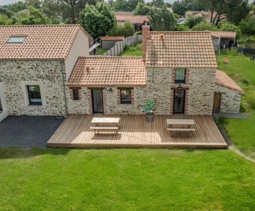 an aerial view of a house with a wooden deck at Grange Rénovée 3 pers-Le GrandLieu-Gîte Le 411 in Saint-Philbert-de-Grand-Lieu