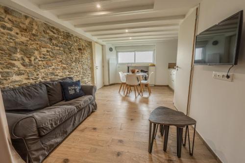 a living room with a couch and a table at Grange Rénovée 3 pers-Le GrandLieu-Gîte Le 411 in Saint-Philbert-de-Grand-Lieu