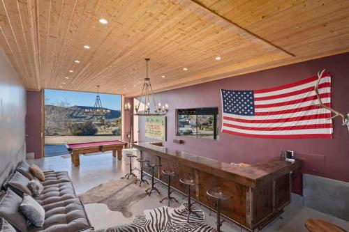 a living room with an american flag on the wall at The Raven By The Cohost Company in Pioneertown