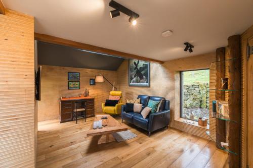 a living room with a couch and a table at Stanage Barn By Birch Stays in Hathersage