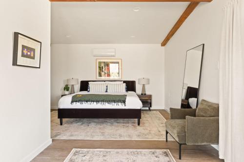 a bedroom with a bed and a couch and a chair at The Raven By The Cohost Company in Pioneertown