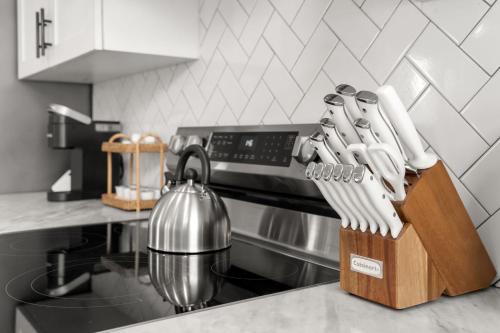 a wooden block of knives on a kitchen counter at NEW! Casa Fuente - Beautifully Renovated Ybor Bungalow, Steps to 7th Ave in Tampa