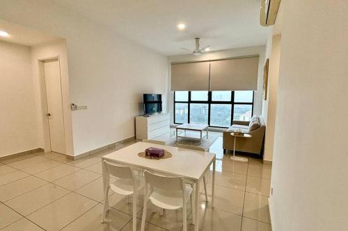 a living room with a white table and chairs at The Icon6 Condo in IOI City Mall Putrajaya, Pool View in Putrajaya