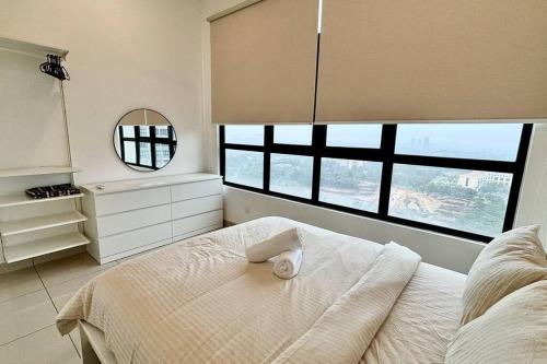 a bedroom with a bed with a mirror and windows at The Icon6 Condo in IOI City Mall Putrajaya, Pool View in Putrajaya